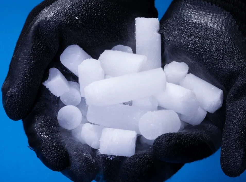 Man in protective gloves holding Dry Ice Pellets